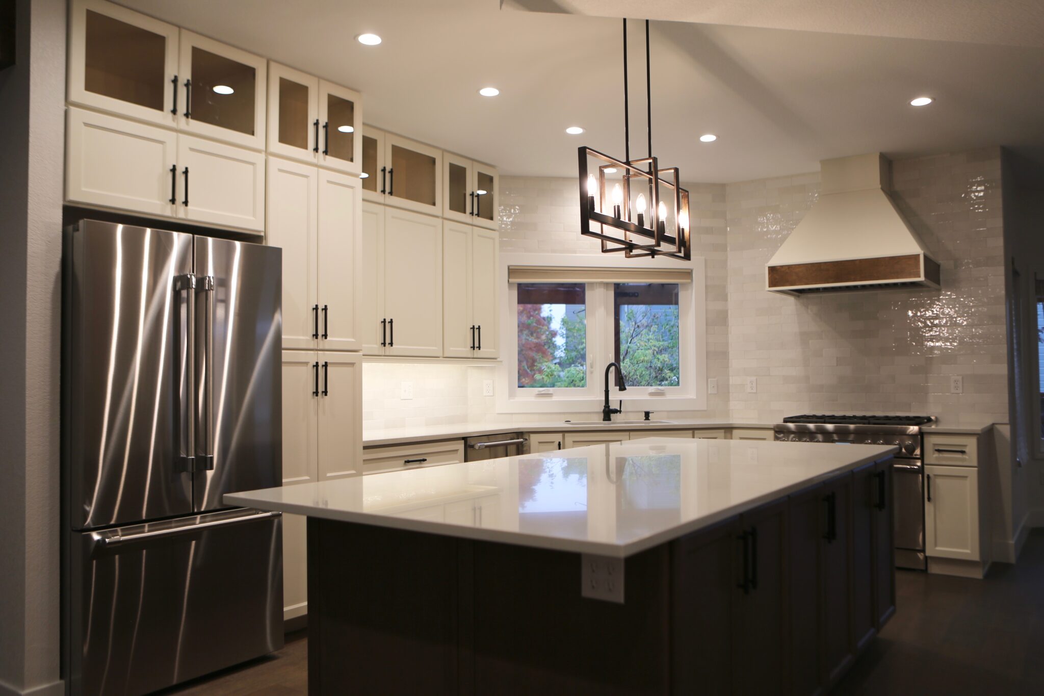 Modern kitchen with stainless steel appliances and pendant lighting